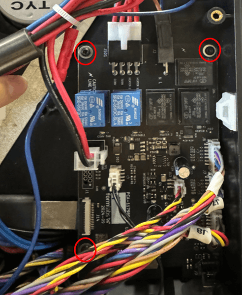 Thread one control board screw into each of the three screw holes highlighted in red.