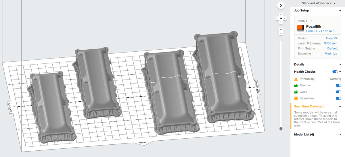PreForm 中显示放置在 Form 3L 构建平台上的四个模型的截图。在 PreForm 中,接缝可以在任何跨越区域大于构建平台 75% 的部件上显示为实线。