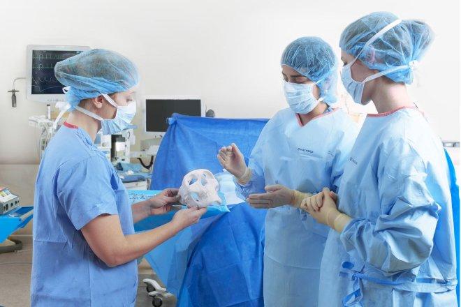 A Medical Team Holds a 3D Printed Skull