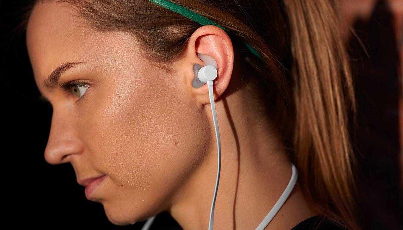 A woman with a custom earbud in her ear